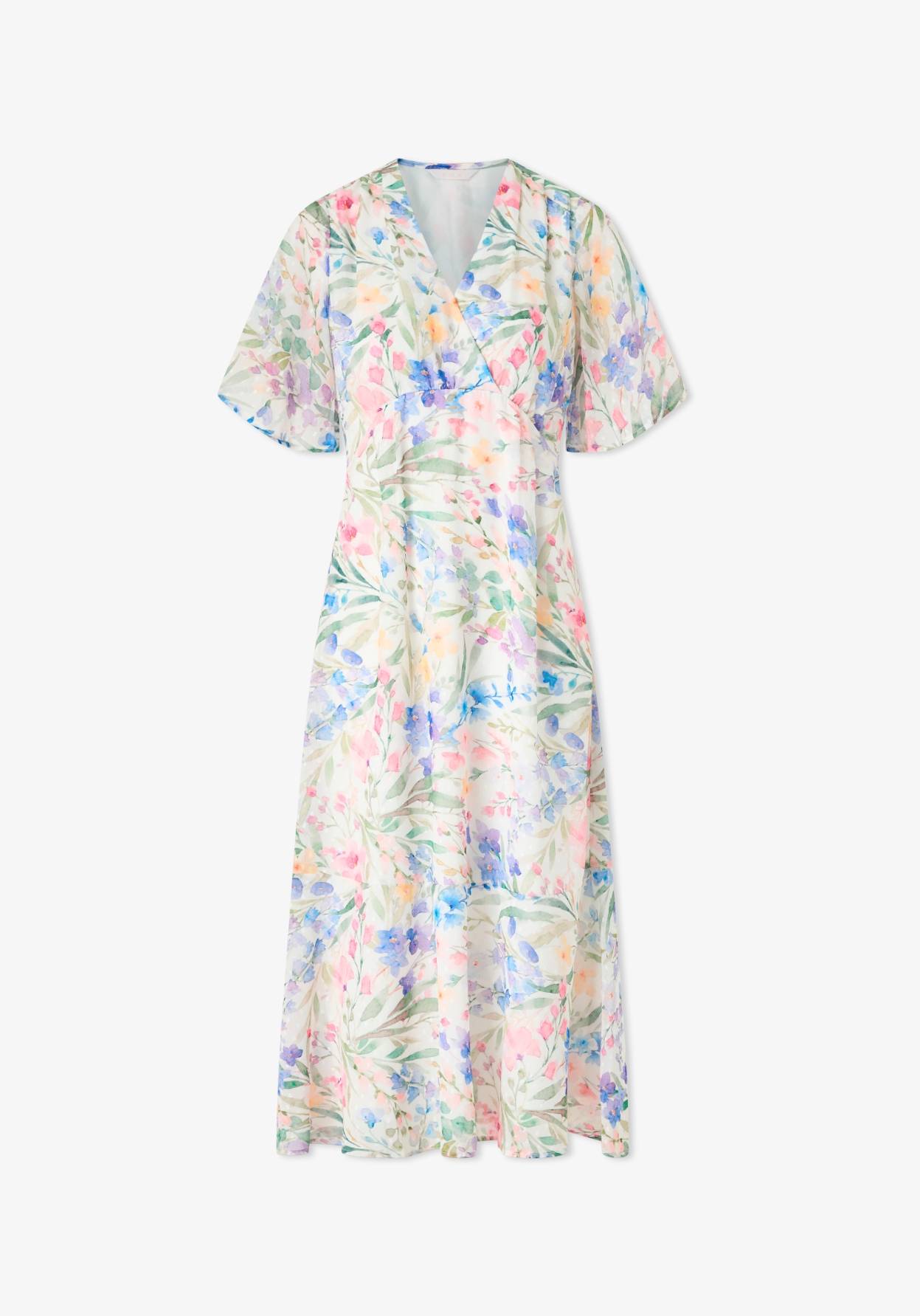 Vaalea mekko värikkäällä kuosilla.