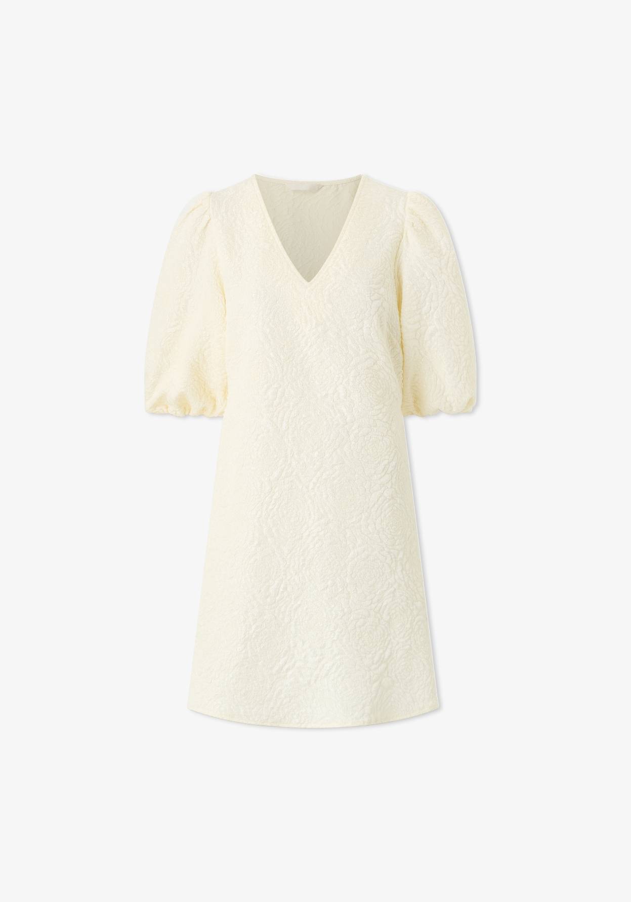 Lyhyt vaalea mekko lyhyillä hihoilla.